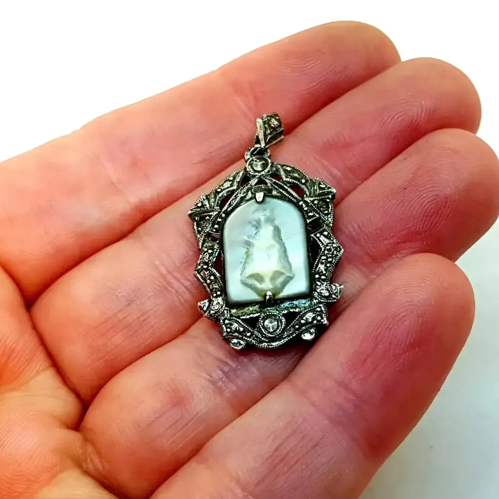 Old art deco religious medal. Mother-of-pearl cameo and silver medal.