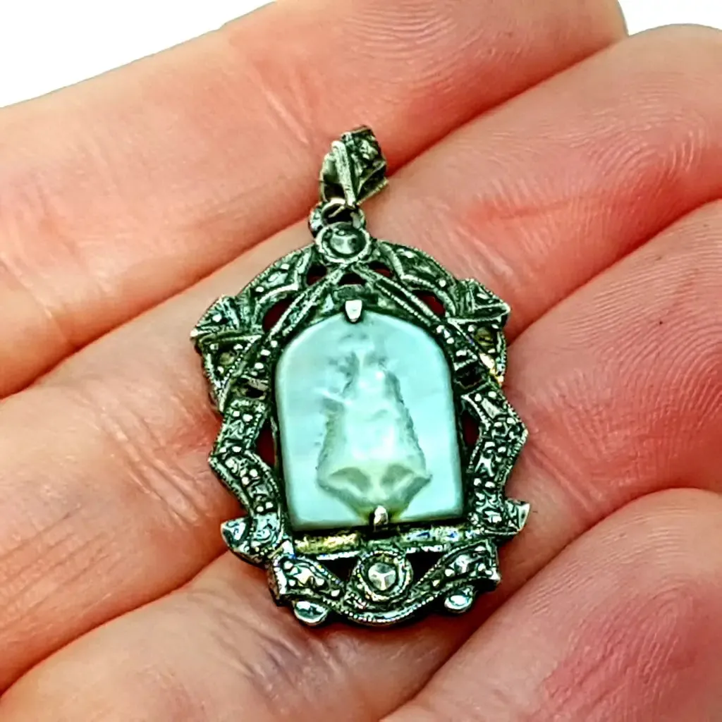 Old art deco religious medal. Mother-of-pearl cameo and silver medal.