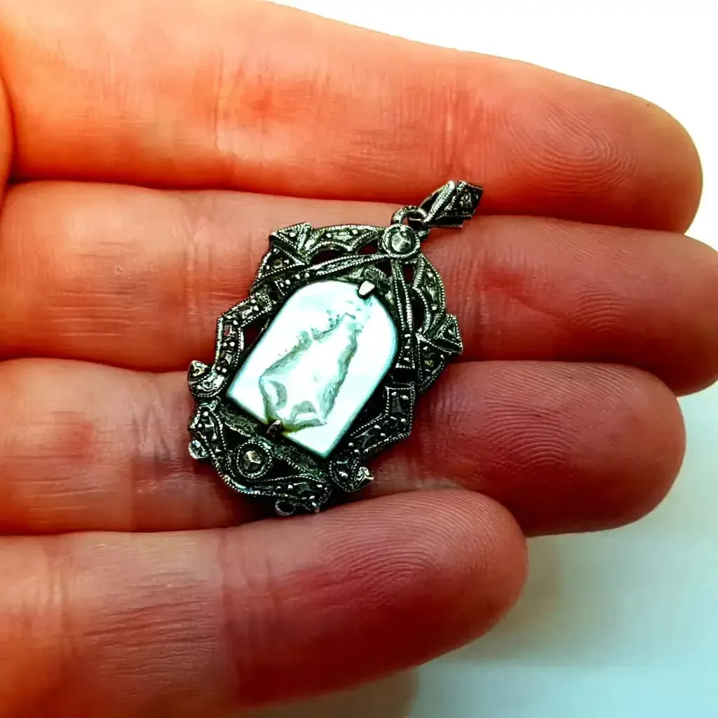 Old art deco religious medal. Mother-of-pearl cameo and silver medal.