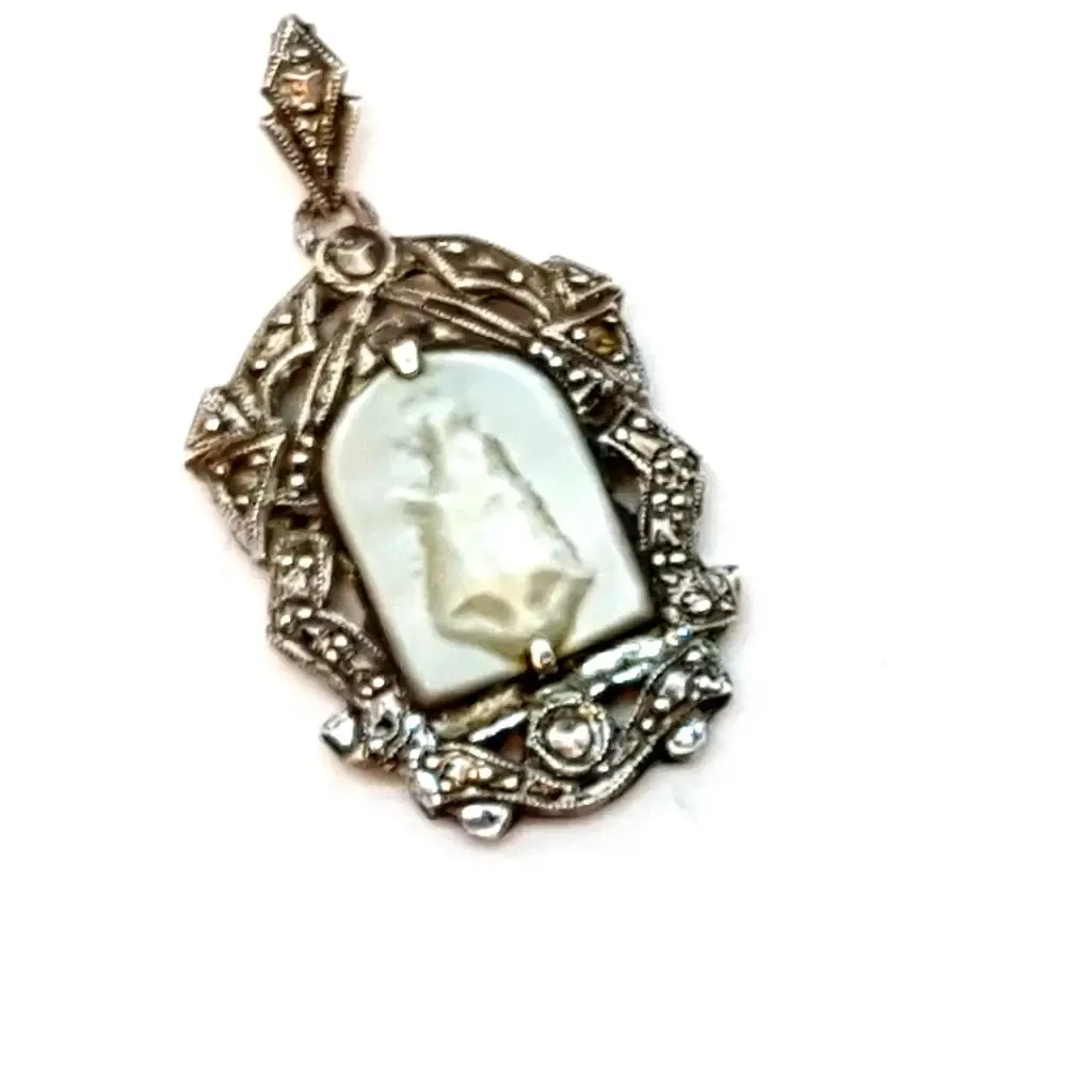 Old art deco religious medal. Mother-of-pearl cameo and silver medal.